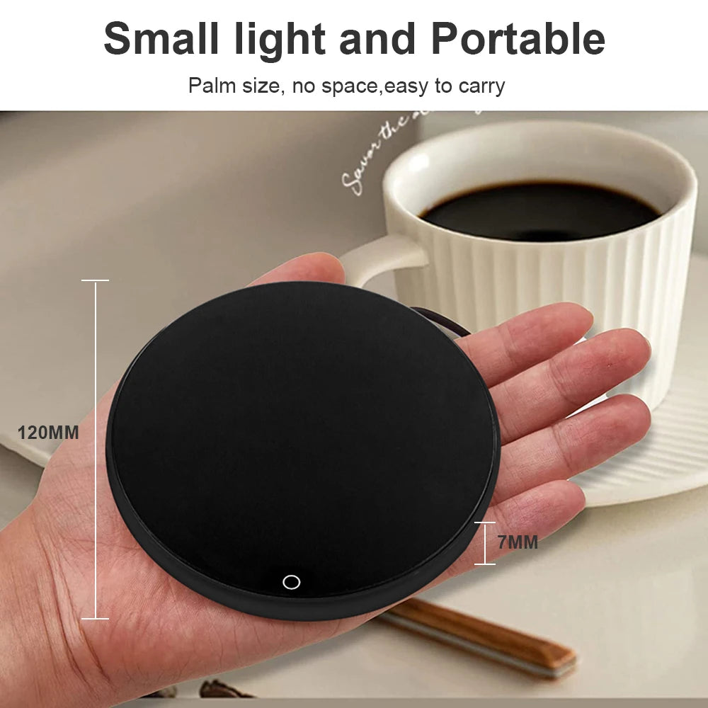 Compact black cup warmer shown in a hand beside a coffee cup